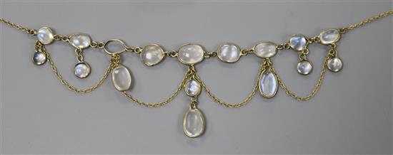 A yellow metal and moonstone set spectacle drop necklace (one stone missing), 42cm.